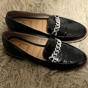 Black loafers with silver chain details